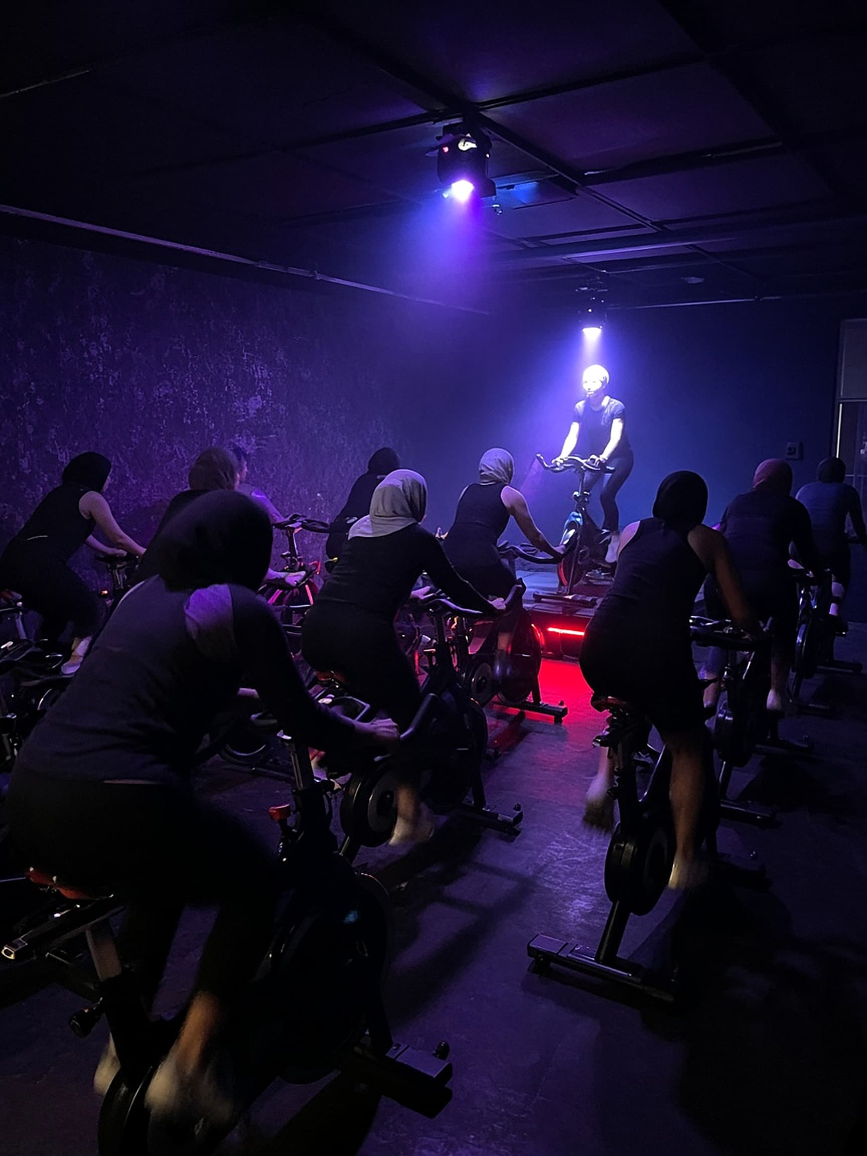 A spin class under studio lights